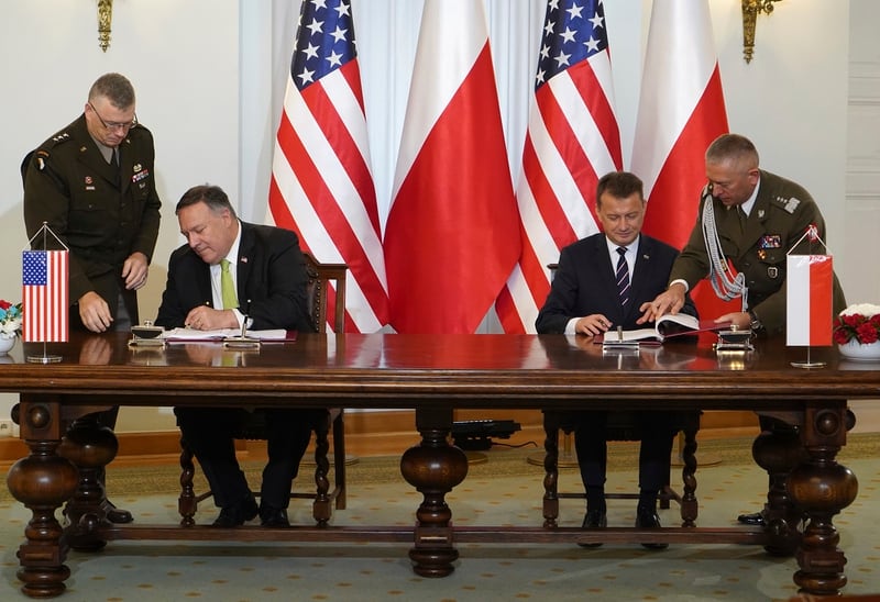 U.S. Secretary of State Mike Pompeo, left, and Poland's Minister of Defence Mariusz Blaszczak sign the U.S.-Poland Enhanced Defence Cooperation Agreement in the Presidential Palace in Warsaw, Poland, Saturday Aug. 15, 2020. (Janek Skarzynski/Pool via AP)