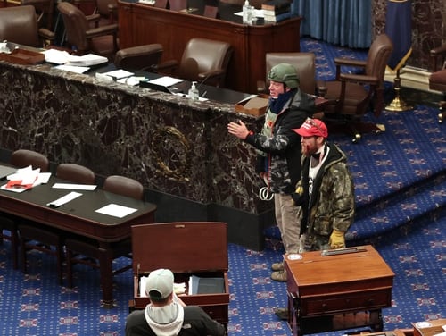 Retired Air Force Lt. Col. Larry Rendall Brock Jr. (in helmet) was photographed on the Senate floor clad in tactical gear and holding flex cuffs. (Win McNamee/Getty Images)