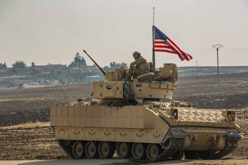 A U.S. soldier sits in the gunner’s seat of a M2 Bradley Infantry Fighting Vehicle in Syria in the Central Command  area of responsibility, Dec. 11, 2020.