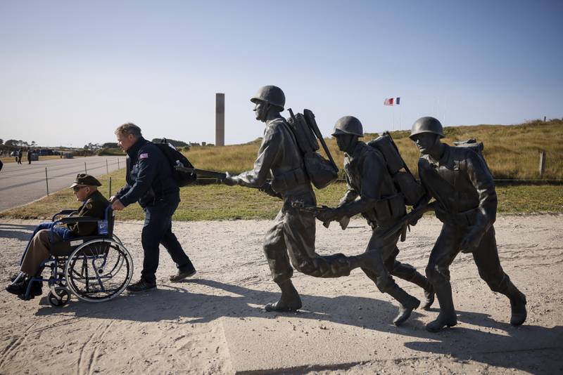 An American veteran is wheeled away after a commemoration organized by the Best Defense Foundation at Utah Beach near Sainte-Marie-du-Mont, Normandy, France, Sunday, June 4, 2023, ahead of the D-Day anniversary.
