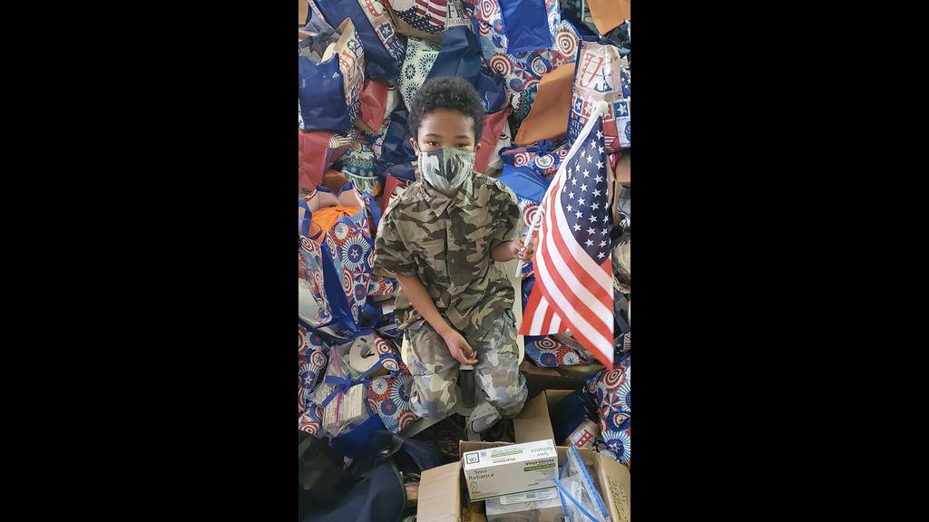 Tyler Stallings with "Hero Bags" he packed for elderly veterans during the COVID-19 pandemic.