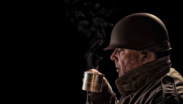 A World War II soldier drinks hot joe out of a tin cup. The military's need for coffee is well-documented, going all the way back to the American Revolution. (Getty Images)