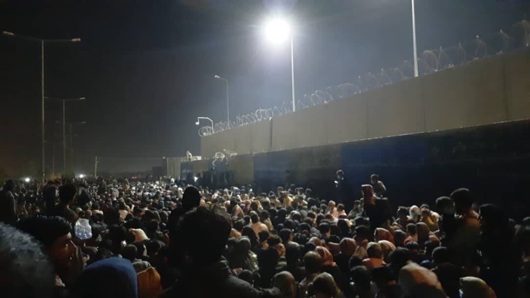 Afghans crowd the area outside the North Gate of the Kabul airport on Aug. 21, 2022. (Mirzahussain Sadid for Alive in Afghanistan)