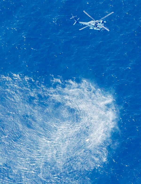 A Japan Air Self-Defense Force helicopter hovers around the sea area where a Japanese fighter jet is believed to have crashed. (Kyodo News via AP)