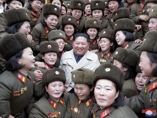 In this undated photo provided Nov. 25, 2019, by the North Korean government, North Korean leader Kim Jong Un, center, poses as he inspects a women's company under Unit 5492 of the Korean People's Army in North Korea. (Korean Central News Agency/Korea News Service via AP)