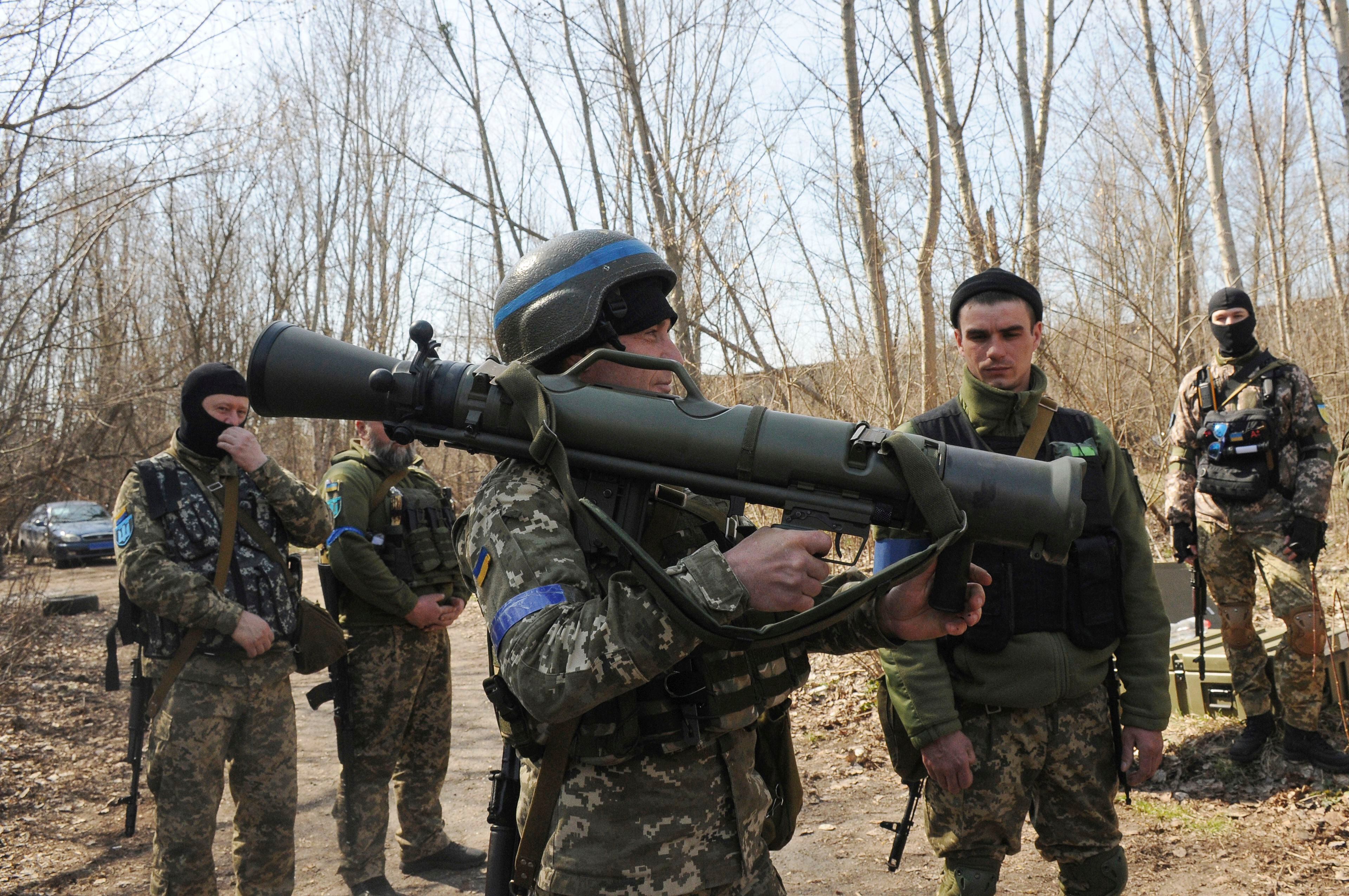 Ukrainian servicemen study a Sweden shoulder-launched weapon system Carl Gustaf M4 during a training session on the near Kharkiv, Ukraine, April 7, 2022. (AP Photo/Andrew Marienko, File)