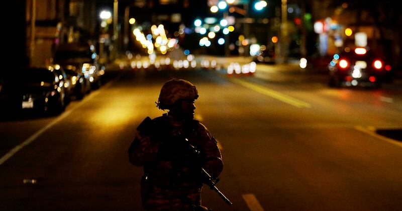 A member of the National Guard walks along North Avenue near where Monday's riots occurred following the funeral for Freddie Gray, after a 10 p.m. curfew went into effect on April 29, 2015, in Baltimore. The National Guard have acknowledged that they can't account for hundreds of ammunition that, at least on paper, were distributed during the unrest. (David Goldman/AP)