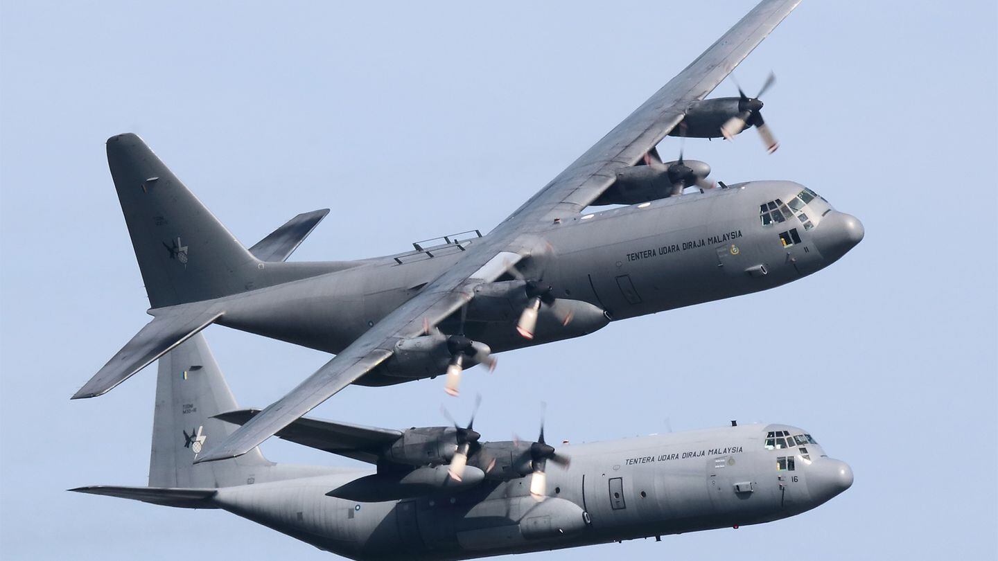 A Lockheed Martin-made C-130H Hercules airlifter of the Royal Malaysian Air Force breaks away from another aircraft on the opening day of LIMA 2023. (Mike Yeo/Staff)
