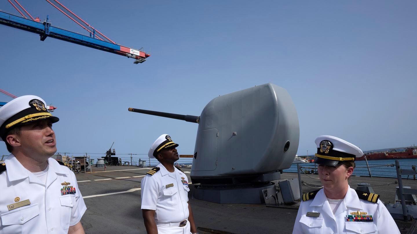 Cmdr. Captain Peter Flynn, left, Cmdr. Executive Officer Tyrchra Bowman, center, and weapons officer Lt. Lindsey Boyle stand on the missile destroyer USS Arleigh Burke, docked in the port in southern city of Limassol, Cyprus, Wednesday, May 17, 2023. (Petros Karadjias/AP)
