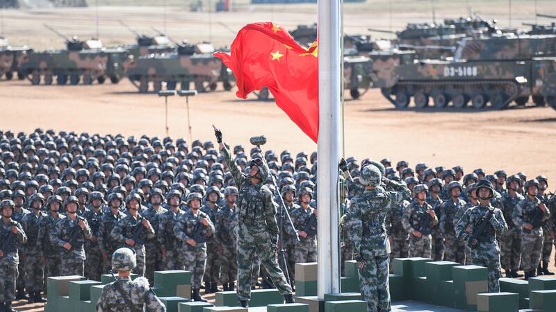 The Chinese flag is raised during a military parade at the Zhurihe training base in China's northern Inner Mongolia region on July 30, 2017. (AFP/Getty Images)