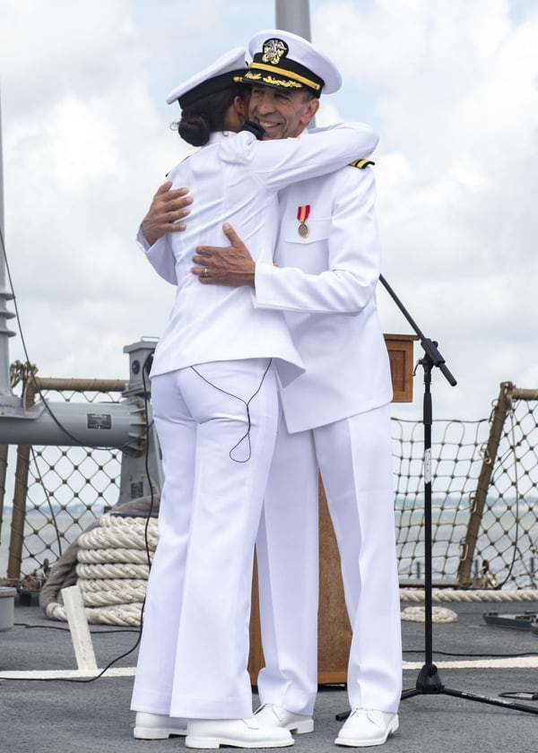 Tyrone Krause, a chief heart surgeon in New Jersey, embraces his daughter, Ensign Laura Krause, after they recited the oath to commission the 63-year-old surgeon as a Navy officer. (MCSN Maxwell Anderson/Navy)