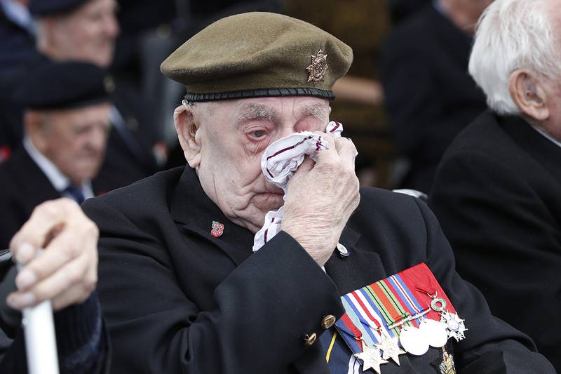 A veteran wipes his eyes during a ceremony to mark the 75th anniversary of D-Day