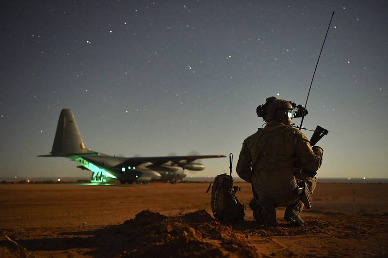 A Special Tactics operator guides a 27th Special Operations Wing MC-130J onto a runway during an exercise Nov. 6, 2020, at Melrose Air Force Range, N.M.