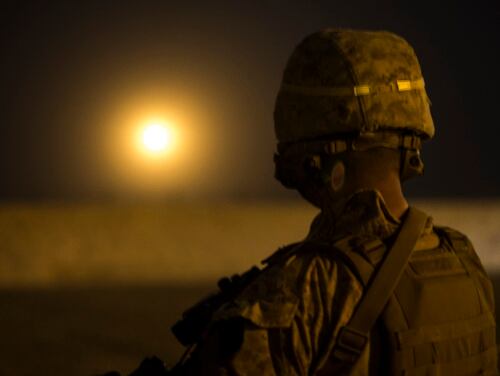 A U.S. Marine with Task Force Southwest looks at a 120mm mortar illumination round fired on Bost Airfield, Afghanistan, April 24, 2018. (Cpl. Roderick L. Jacquote/Marine Corps)