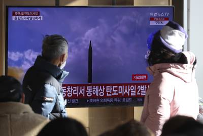 People watch a TV screen showing a news program about North Korea's missile launch with file footage, at the Seoul Railway Station in Seoul, South Korea, Sunday, Dec. 18, 2022.