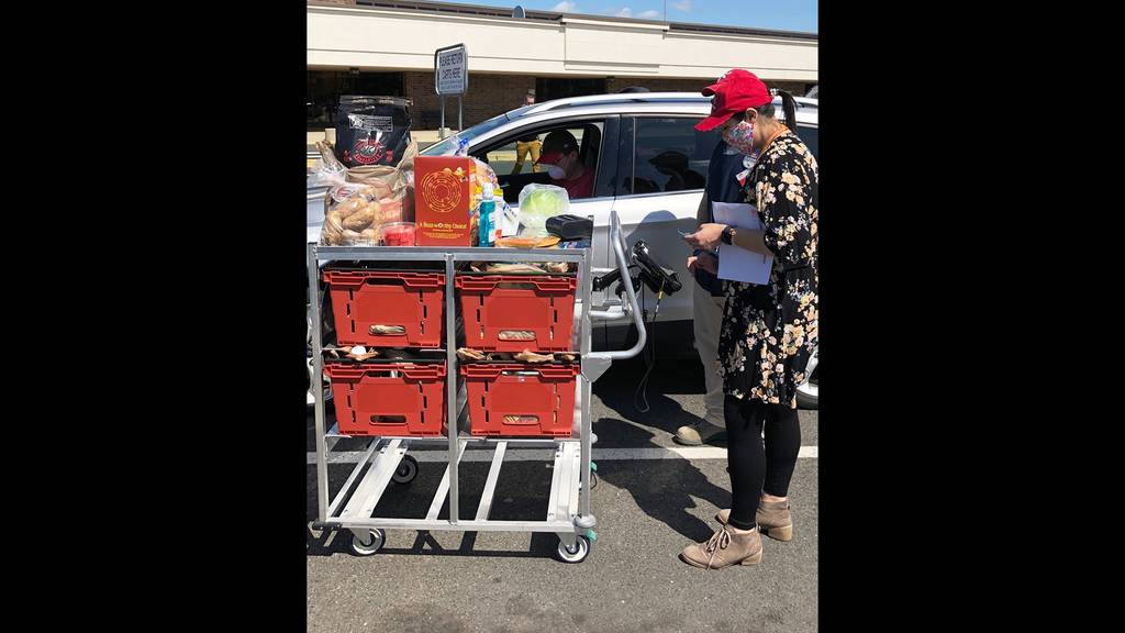 McGuire Air Force Base Commissary assistant store manager Ashley Moats delivers groceries to the vehicle of one of the store’s first CLICK2GO customers.
