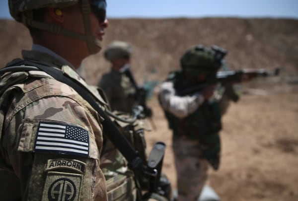 TAJI, IRAQ - APRIL 12: U.S. Army trainers watch as an Iraqi recruit fires at a military base on April 12, 2015 in Taji, Iraq. U.S. forces, currently operating in 5 large bases throught the country, are training thousands of Iraqi Army combat troops, trying to rebuild a force they had origninally trained before the U.S. withdrawal from Iraq in 2010. Members of the U.S. Army's 5-73 CAV, 3BCT, 82nd Airborne Division are teaching members of the newly-formed 15th Division of the Iraqi Army, as the Iraqi government launches offensives to try to recover territory lost to ISIS last year. (Photo by John Moore/Getty Images)