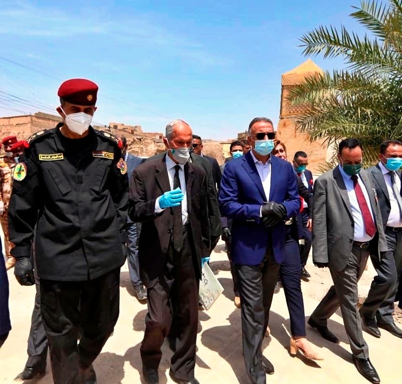 Iraqi Prime Minister Mustafa al-Kahdimi, center, visits the site of the Al–Nuri mosque, which was destroyed by Islamic State militants, during his visit to Mosul, Iraq, Wednesday, June 10, 2020. (Iraqi Prime Minister Media Office, via AP)