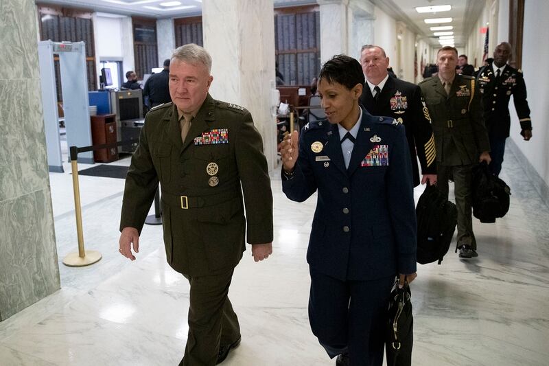 U.S. Marine Corps Gen. Kenneth McKenzie Jr., commander of U.S. Central Command, left, walks to a House Armed Services hearing on Capitol Hill on March 10, 2020, in Washington. (Alex Brandon/AP)