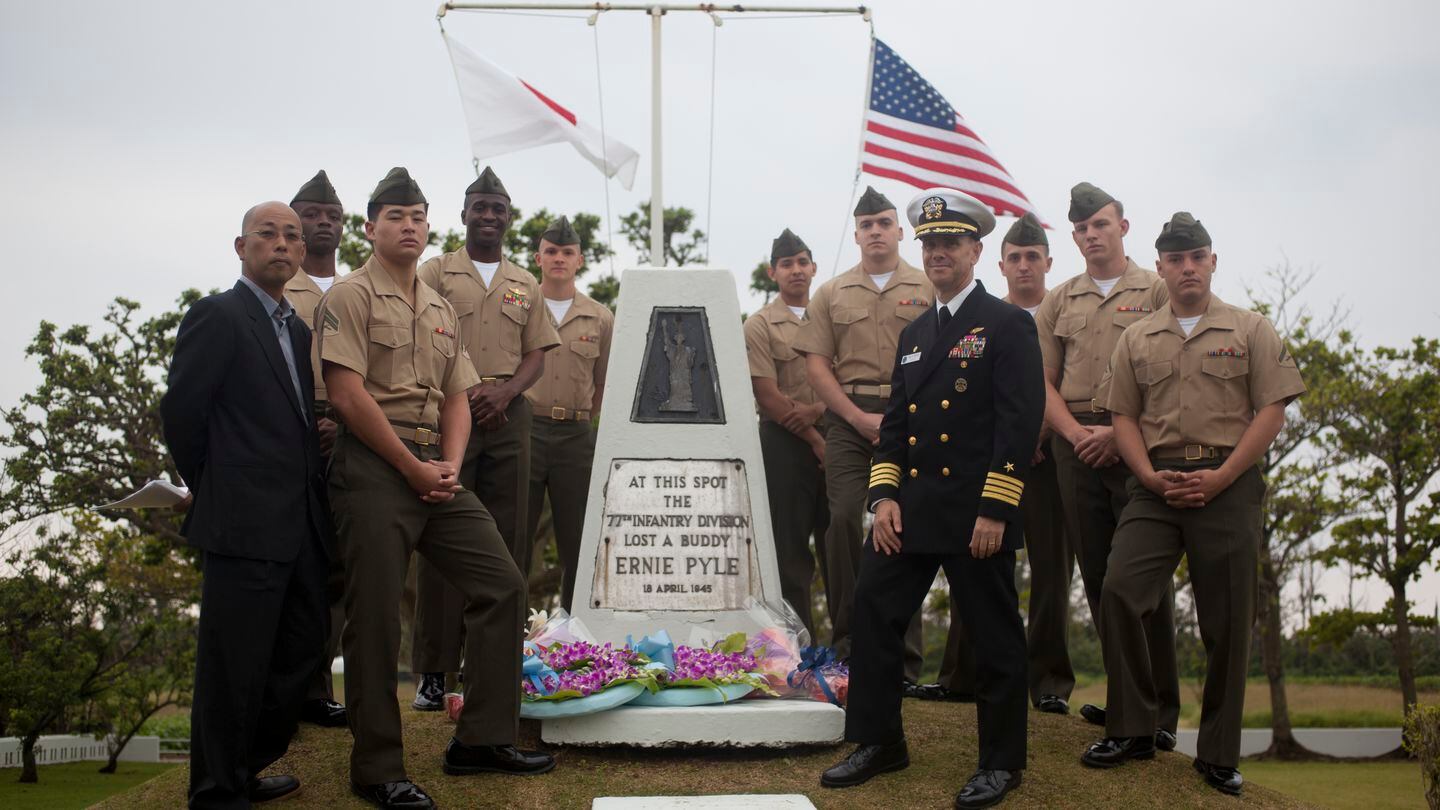 U.S. service members and an Okinawan pose for a photo at the Ernie Pyle Memorial after the memorial ceremony on Ie Shima, Okinawa, Japan, April 14, 2013. Ernie Pyle was killed during the battle of Okinawa. (Lance Cpl. Tyler S. Dietrich III/Marine Corps)