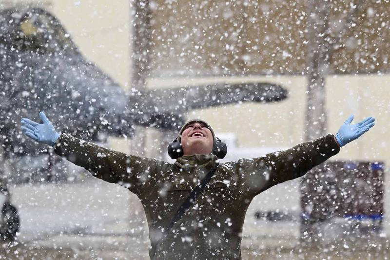 A U.S. Air Force crew chief enjoys the snow at Davis-Monthan Air Force Base, Ariz., Jan. 26, 2021. The last time it snowed at Davis-Monthan was approximately two years ago, so the snow was a surprise for maintainers working the flightline.