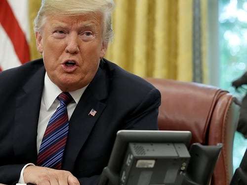 President Donald Trump speaks on the telephone via speakerphone with Mexican President Enrique Pena Nieto in the Oval Office of the White House on Aug. 27, 2018 in Washington, D.C. (Win McNamee/Getty Images)