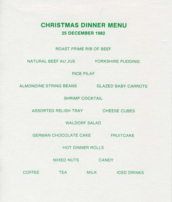 Christmas Dinner Menu, 25 December 1982, Roast Prime Rib of Beef, Natural Beef Au Jus, Yorkshire Pudding, Rice Pilaf, Almondine String Beans, Glazed Baby Carrots, Shrimp Cocktail, Assorted Relish Tray, Cheese Cubes, Waldorf Salad, German Chocolate Cake, Fruitcake, Hot Dinner Rolls, Mixed Nuts, Candy, Coffee, Tea, Milk, Iced Drinks.