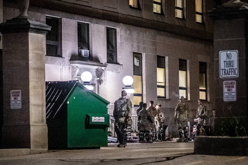 Members of the National Guard wait inside the Kenosha County Court House building during a demonstration against the shooting of Jacob Blake in Kenosha, Wis., on Aug. 26, 2020.