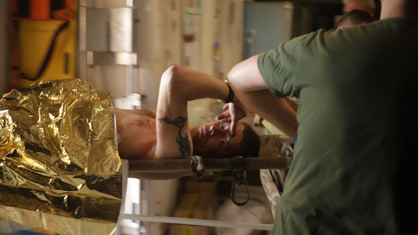 An injured man is treated at a stabilization point near Bakhmut, Ukraine, in July. (Thomas Mutch for Military Times)