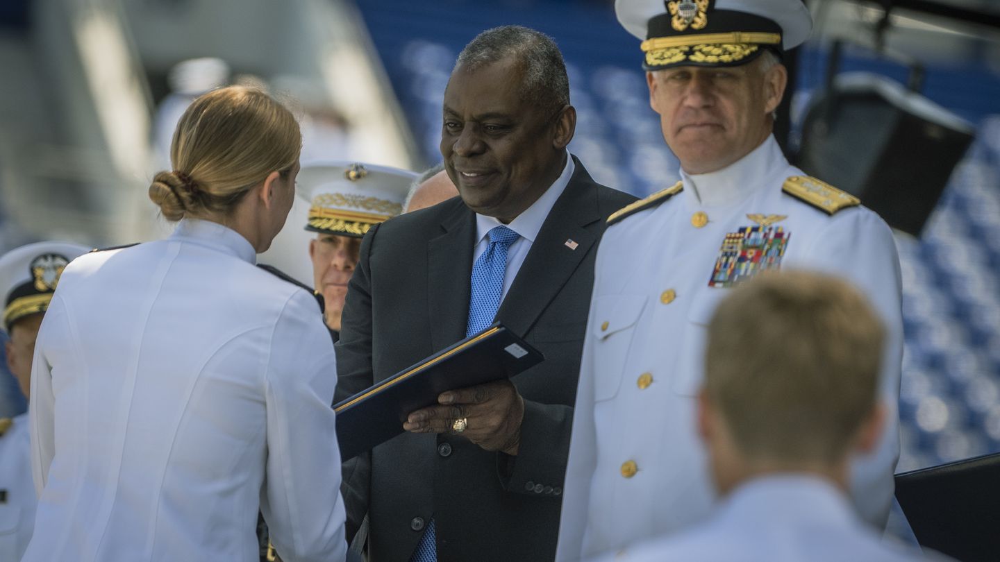 Secretary of Defense Lloyd J. Austin III awards a diploma at the U.S. Naval Academy's Class of 2023 graduation ceremony May 26. (Chad J. McNeeley/DoD)