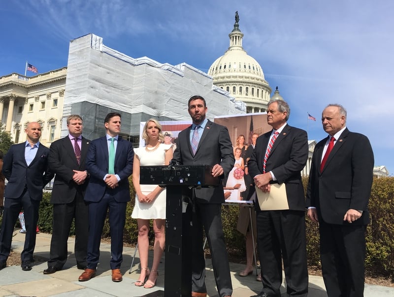 Rep. Duncan Hunter, R-Calif., third from right, speaks at a rally on Capitol Hill supporting Special Warfare Operator Chief Edward Gallagher, facing war crimes charges for actions in Afghanistan. With him are Gallagher's wife, Andrea; his brother, Sean, third from left; Rep. Ralph Norman, R-N.C., second from right; and Rep. Steven King, R-Iowa, right. (Leo Shane III/Staff)