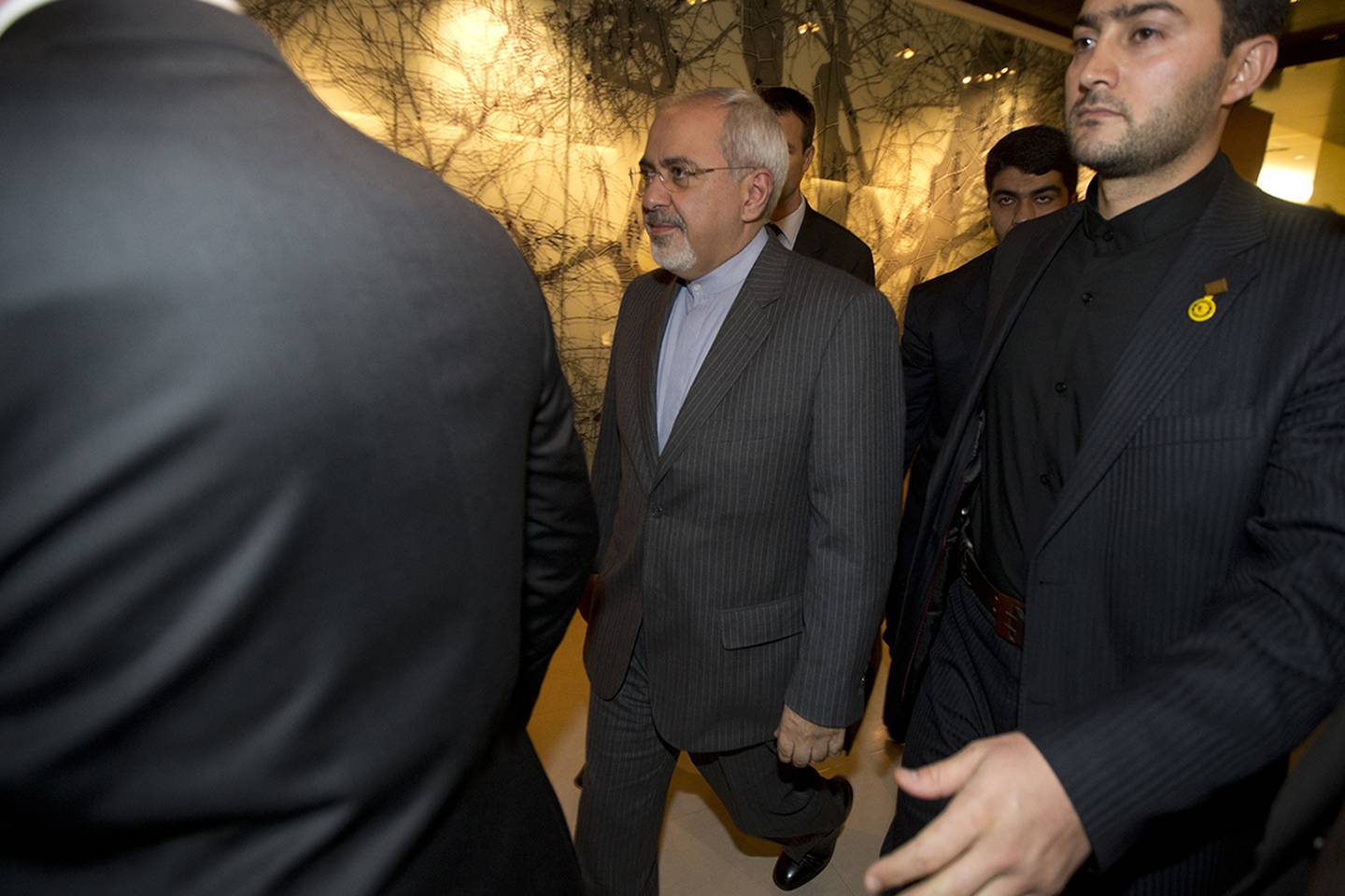 In this Nov. 9, 2013, file photo, Iranian Foreign Minister Mohammad Javad Zarif, center, leaves following a meeting with EU foreign ministers at the Iran Nuclear talks in Geneva, Switzerland.