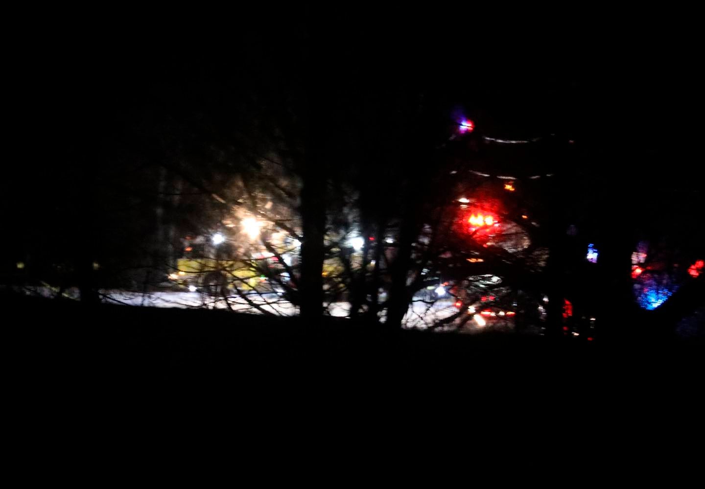 Mendon firefighters and other emergency personnel respond to a military helicopter crash in a field near Cheese Factory Road and W. Bloomfield Road in Mendon, N.Y., late Wednesday, Jan. 20, 2021.
