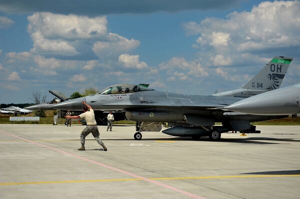 Senior Airman Bradley Asbury, an F-16 Fighting Falcon mechanic assigned to the 180th Fighter Wing of the Ohio Air National Guard, launches an aircraft for a training mission at Kecskemet Air Base, Hungary. (Senior Master Sgt. Beth Holliker/Air National Guard)