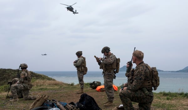 A U.S. Air Force combat control airman from the 320th Special Tactics Squadron and U.S. Marine Corps joint terminal attack controllers from the 5th Air Naval Gunfire Liaison Company, III Marine Expeditionary Force, call in close air support March 10, 2017, at the Irisuna Jima Training Range, Okinawa, Japan. (Senior Airman John Linzmeier/Air Force)