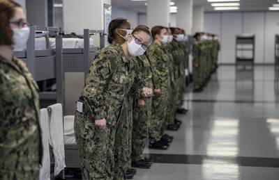 Seaman recruit Shanda Martinez, a recruit chief petty officer, checks to see if her division is ready for their first task during a dynamic material inspection Dec. 21, 2020, at Recruit Training Command at Great Lakes, Ill.