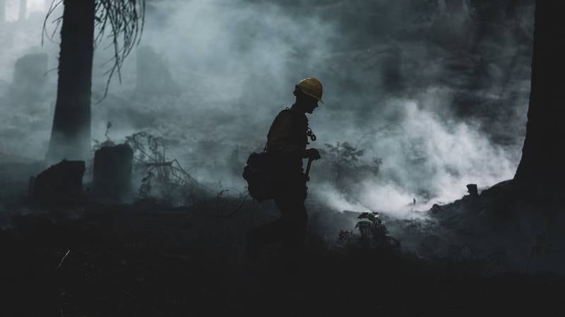 A U.S. Marine assigned to the 7th Engineer Support Battalion, 1st Marine Logistics Group, conducts wildland firefighting operations in O'Neals, Calif., near the Sierra National Forest, Sept. 26, 2020.
