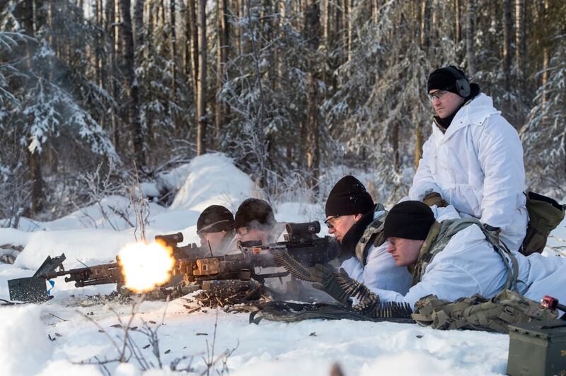 Army paratroopers assigned to the 25th Infantry Division, U.S. Army Alaska, fire the M240L machine gun while providing support-by-fire during training at Joint Base Elmendorf-Richardson, Alaska, Feb. 2. (Alejandro Peña/Air Force)