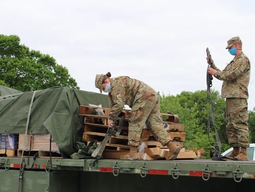 Nebraska Army National Guard soldiers secure cargo after delivering essential supplies to a mobile testing site at the Seward County Fairgrounds in Seward, Neb., May 27, 2020. (Staff Sgt. Heidi McClintock/Nebraska National Guard)
