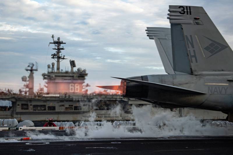 An F/A-18E Super Hornet launches from the flight deck of USS Theodore Roosevelt (CVN 71) while conducting dual-carrier operations with the Nimitz Carrier Strike Group in the South China Sea on Feb. 9, 2021.