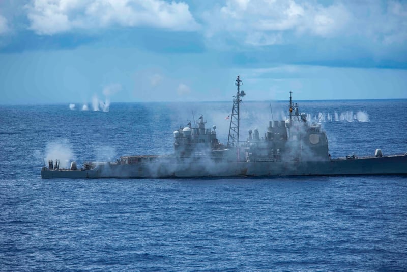 The guided-missile cruiser Antietam fires its 5-inch gun during Tuesday's demonstration in the Philippine Sea. (MC3 Quinton Lee/Navy)