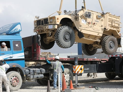 A Mine Resistant Ambush Protected vehicle is loaded on a flatbed trailer as part of the Army Field Support Battalion - Afghanistan, 10th Mountain Division Resolute Support Sustainment Brigade retrograde cargo operation on Bagram Air Field, Afghanistan, July 12, 2020. (Sgt. 1st Class Corey Vandiver/Army)