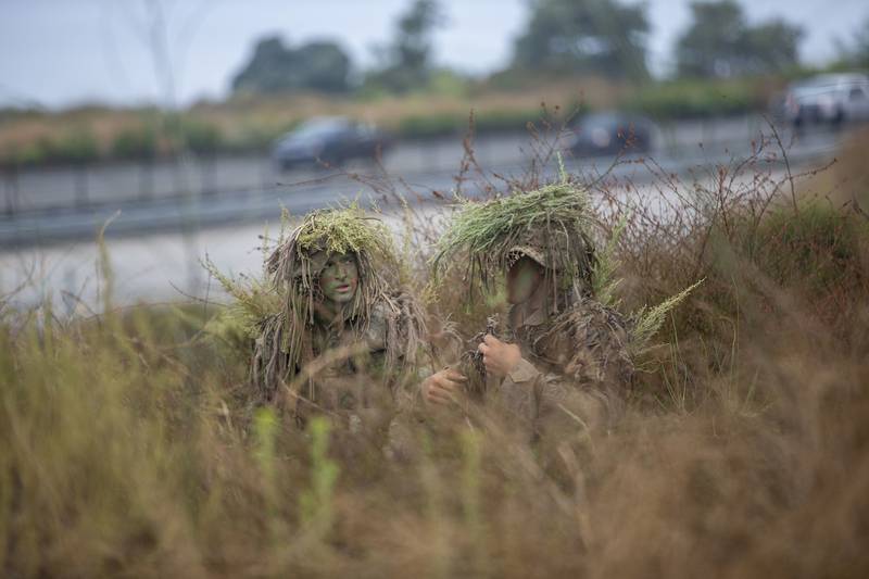 Marines with the Scout Sniper Course, Reconnaissance Training Company, Advanced Infantry Training Battalion, School of Infantry - West, work to conceal themselves during an exercise in the Romeo Training Area on Marine Corps Base Camp Pendleton, Calif., July 27, 2020.