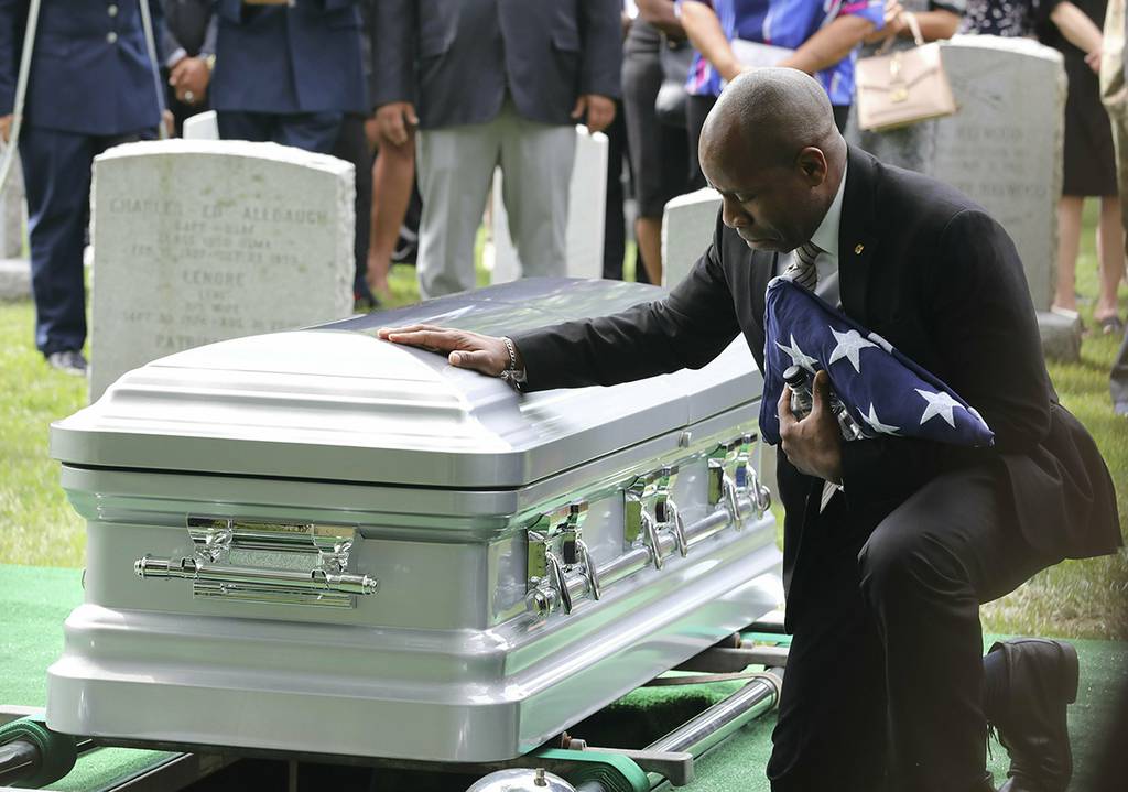 Christopher C. Morgan touches the casket of his son, West Point Cadet Christopher J. Morgan, during the interment ceremony at West Point, N.Y