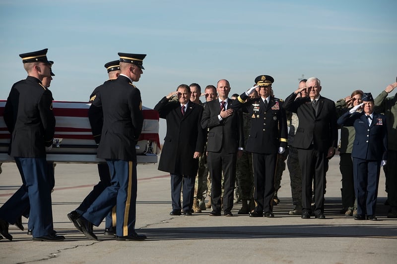 From left, Gov. Gary Herbert, Lt. Gov. Spencer J. Cox, Maj. Gen. Jefferson S. Burton, Civilian Aid to the Secretary of the Army John Edwards, and Brig. Gen. Christine Burckle salute as members of the Utah National Guard Honor Guard carry a casket containing the remains of Maj. Brent R. Taylor at at the National Guard base Wednesday, Nov. 14, 2018. in Salt Lake City. The remains of a Utah mayor killed while serving in the National Guard in Afghanistan were returned to his home state on Wednesday, Nov. 14, 2018, as hundreds of soldiers saluted while his casket covered in an American flag was carried across a tarmac and into a hearse. (Matt Herp/Standard-Examiner via Pool)