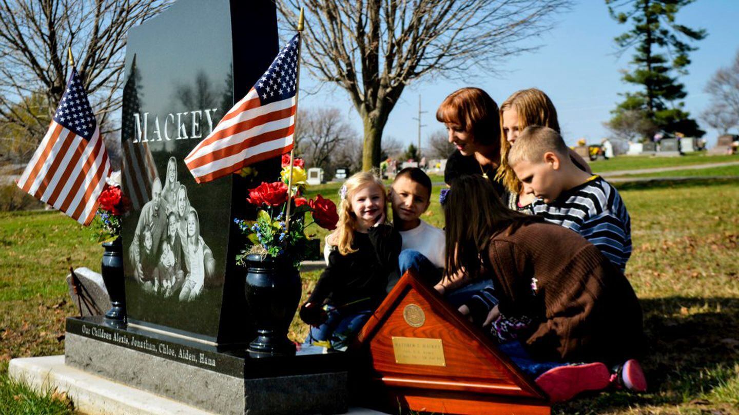 Kaanan Fugler, surviving spouse of Staff Sgt. Matthew Mackey, visits his grave with her children. (Courtesy of Kaanan Fugler)