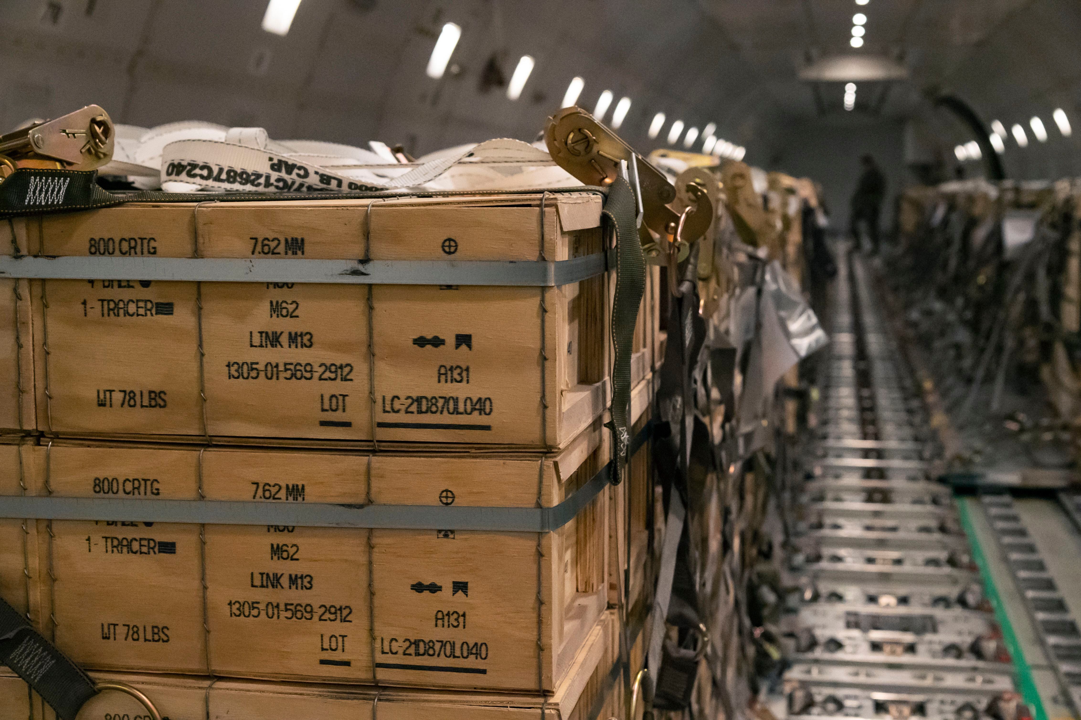 Pallets of ammunition, weapons and other equipment bound for Ukraine are loaded on a plane by members from the 436th Aerial Port Squadron during a foreign military sales mission at Dover Air Force Base, Del., on Jan. 30, 2022. (Senior Airman Stephani Barge/U.S. Air Force via AP)