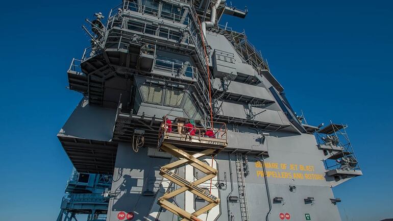 The island of the next-gen carrier Gerald R. Ford gets worked on by shipyard workers. (Mark D. Faram/Staff)