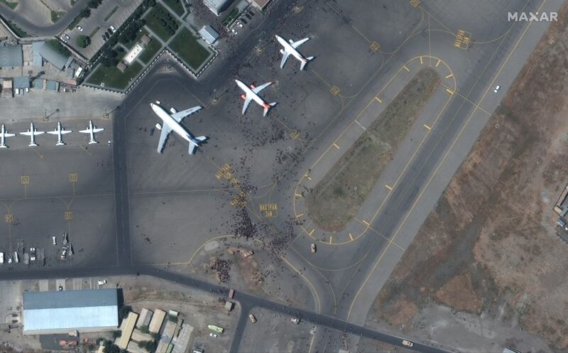 Satellite imagery shows crowds of people gathered on the tarmac at Hamid Karzai International Airport in Afghanistan as thousands of people try to exit the country. (Courtesy of Maxar Technologies)