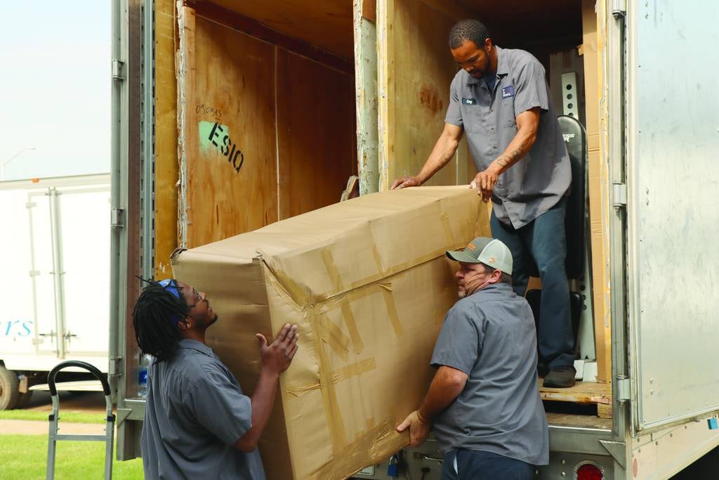 Workers from River City Movers conduct a direct delivery for a service member whose belongings were transported overseas from his previous duty station in Germany during a government move to Fort Campbell, Ky., on May 9, 2022.